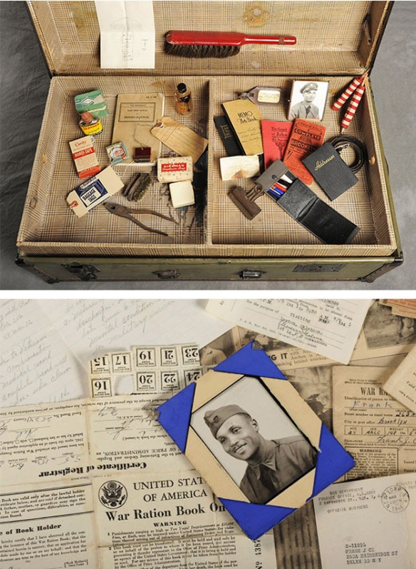Suitcase showing war porait and ration book, other personal items