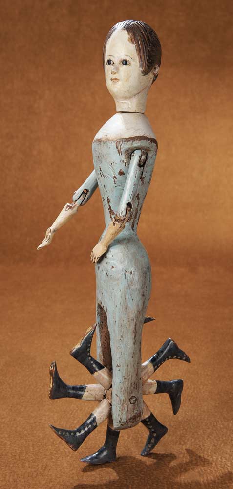 Rare early nineteenth century walking doll with eight legs that rotate like a wheel.