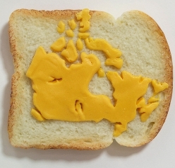 Map of Canada made from processed cheese on white bread made by Tibi Tibi Neuspiel.