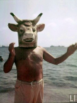 Pablo Picasso wearing a bull's mask.