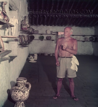 Pablo Picasso shirtless with pottery