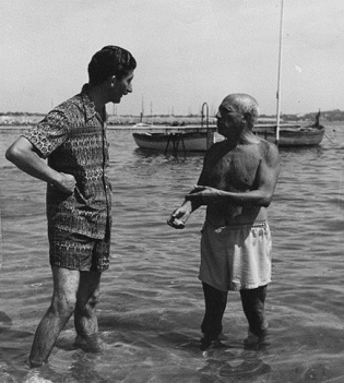 Pablo Picasso shirtless boat in background.