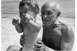 Picasso without his shirt on with a baby