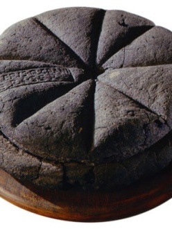 Photograph of a preserved circular loaf of bread discovered at Pompeii